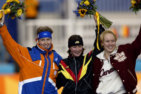 Cindy Klassen (right) of Winnipeg, bronze medalist in the women's 3,000 metre speed skating at the flower ceremony with gold medal winner Claudia Pechstein (centre) of Germany and silver medalist Renata Groenewold of the Netherlands at the Salt Lake City