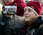 Canada's Olympic women's hockey team player Cheryl Pounder from Mississauga Ont. films while attending the Canadian flag-raising at the Olympic Village in Salt Lake City, Utah Thursday Feb. 7, 2002. (CP PHOTO/HO/COA/Andre Forget)