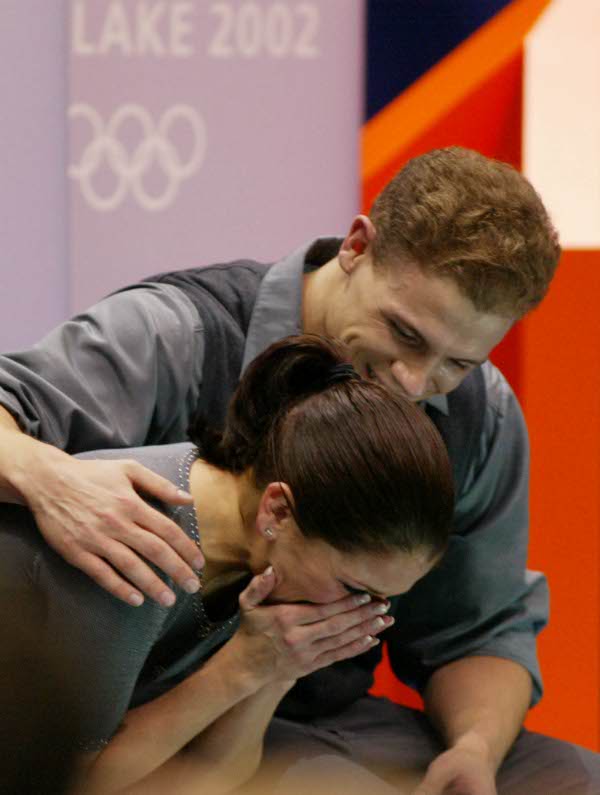 Canadian David Pelletier holds Jamie Sale after hearing their marks after completing their Pairs Free Skating in Salt Lake City, Utah Monday Feb. 11, at the 2002 Winter Olympics. They won a Silver medal for their skate.  (They will be co-awarded the gold later on after an ISU's decision.) (CP Photo/HO/COA/Andre Forget)