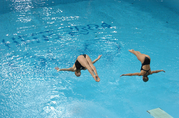 Blythe Hartley (L) and team mate Emilie Heymans dive during the Synchronised Diving 3m Springboard at the Athens 2004 Summer Olympic Games August 14, 2004.  The pair finished seventh. (CP PHOTO 2004/Andre Forget/COC)