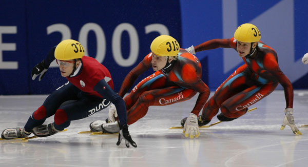 Canadian Short Track skaters Marc Gagnon (315) and Jonathan Guilmette (316) follow on the heals of American Rusty Smith during the Men's 500 metre Saturday Feb. 23, 2002 at the 2002 Olympic Winter Games in Salt Lake City. Canadian Gagnon went on to win gold Guilmette won silver and Smith bronze. (CP Photo/COA/Andre Forget).