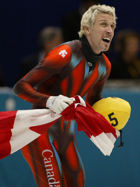 Canadian Short Track double Gold medallist Marc Gagnon carries the Canadian flag after winning gold in the Men's 500 metre Saturday Feb. 23, 2002 at the 2002 Olympic Winter Games in Salt Lake City. (CP Photo/COA/Andr Forget).