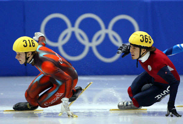 Canadian Short Track speed skater Jonathan Guilmette (316) outskates to the American Apolo Ohno (369) during the Men's 500 metre Saturday Feb. 23, 2002 at the 2002 Olympic Winter Games in Salt Lake City. Canadian Guilmette won silver and Smith bronze. (CP Photo/COA/Andre Forget).
