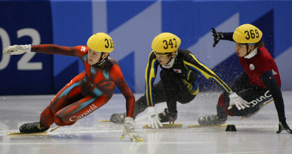 Canadian Short Track speed skaters Jonathan Guilmette (316) races against two competitors at the 2002 Olympic Winter Games in Salt Lake City.  (CP Photo/COA/Andre Forget).