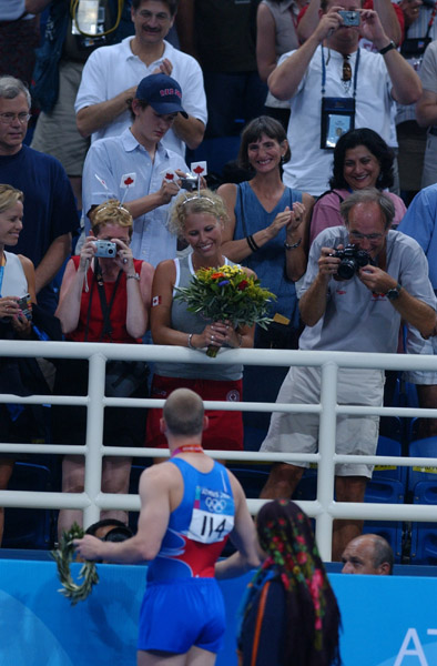 Canada's Kyle Shewfelt gives his flowers to his girlfriend after winning the gold medal at the men's floor routine at the 2004 Summer Olympic Games in Athens on Sunday August 22, 2004. (CP PHOTO 2004/Andre Forget/COC) Kyle