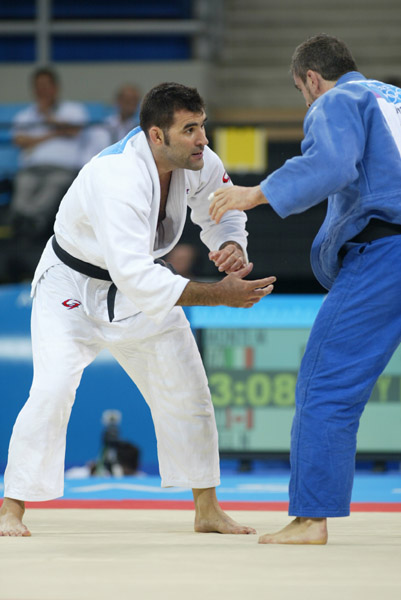 Canada's Nicolas Gill, (white) from Montreal, in the -100kg judo competition against Italy's Michele Monti  at the Summer Olympic Games in Athens Thursday, August 19, 2004. Gill, Canada's flag bearer and medal hopefull, lost the first round match. (CP PHOTO/COC-Mike Ridewood)