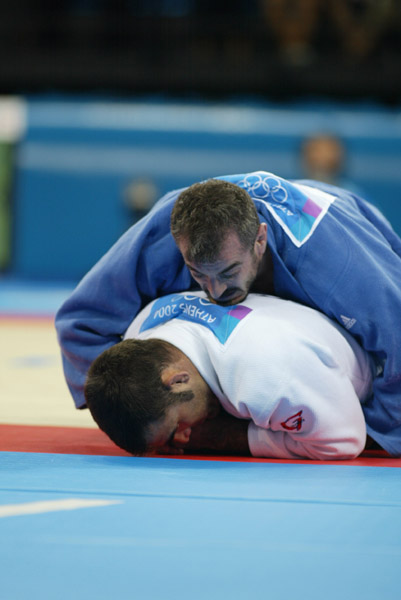 Canada's Nicolas Gill, (white) from Montreal, lost the first round match in the -100kg judo competition against Italy's Michele Monti  at the Summer Olympic Games in Athens Thursday, August 19, 2004.  (CP PHOTO/COC-Mike Ridewood)