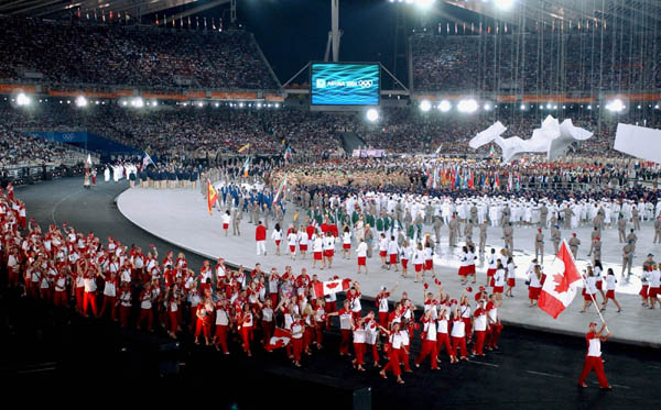 Canadian flag bearer Nicolas Gill brings in the Canadian team during the opening ceremony of the Athens 2004 Summer Olympic Games August 13, 2004. (CP PHOTO/Andre Forget, COC)