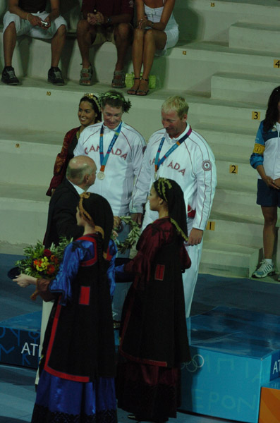 Canada's Ross MacDonald (left) of Vancouver, BC, and Mike Wolfs (right) of Port Credit, Ontario, receive their silver medal won in the star sailing event at the 2004 Summer Olympic Games in Athens on Saturday August 28, 2004. (CP PHOTO 2004/Andre Forget/COC)