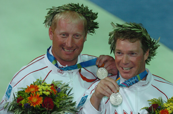 Canada's Ross MacDonald (right) of Vancouver, BC, and Mike Wolfs (left) of Port Credit, Ontario, show their silver medal in the star sailing event at the 2004 Summer Olympic Games in Athens on Saturday August 28, 2004. (CP PHOTO 2004/Andre Forget/COC)