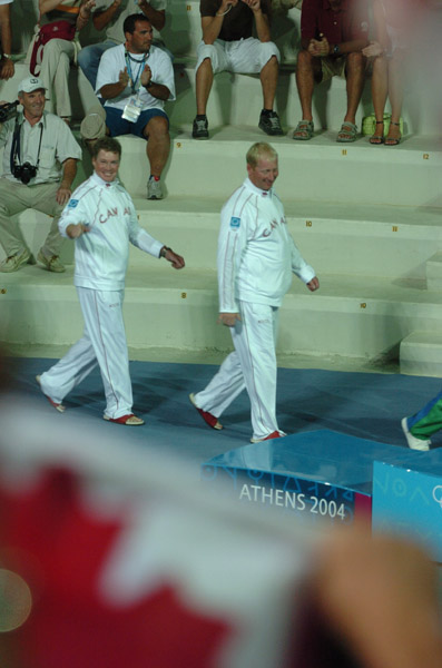 Canada's Ross MacDonald (left) of Vancouver, BC, and Mike Wolfs (right) of Port Credit, Ontario, on their way to the podium to receive their silver medal in the star sailing event at the 2004 Summer Olympic Games in Athens on Saturday August 28, 2004. (CP PHOTO 2004/Andre Forget/COC)