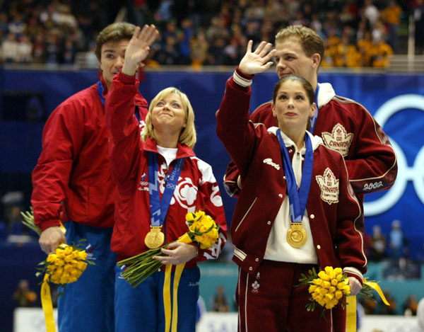 Gold medalists David Pelletier and Jamie Sale stand next to Russians Anton Sikharulidze and Elena Berezhnaya after being presented their gold medals Sunday Feb. 17, at the 2002 Olympic Winter Games. (CP Photo/COA/Andre Forget).