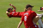 Canada's Cindy Eadie (#9), Auburn Sigurdson (#24), Kaila Holtz (#27), and Rachel Schill (#6) celebrate with other teammates their win against Taipei in the preliminary game in the softball tournament on August 14, 2004 at the Olympic Games in Athens. (CP PHOTO)2004(COC-Mike Ridewood)