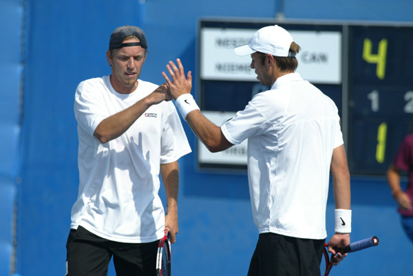 Frederic Niemeyer (left) of Campbellton, N.B. and Daniel Nestor of Willowdale, Ont. won the first round of doubles tennis against Slovakia at the Olympic Games in Athens, Sunday, August 15, 2004. (CP PHOTO/COC-Mike Ridewood)