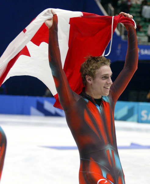 Canadian Short Track Gold medallist Francois-Louis Tremblay carries the canadian flag after winning gold in the men's 5,000 metre relay Saturday Feb. 23, 2002 at the 2002 Olympic Winter Games in Salt Lake City. (CP Photo/COA/Andre Forget).