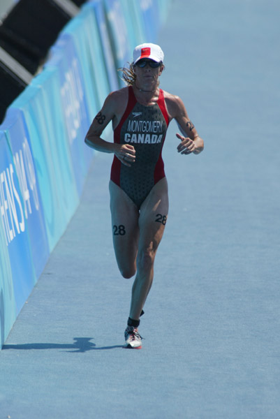 Canada's Carol Montgomery of Vancouver crosses the line to finish 35th in the women's triathlon at the Olympic Games in Athens, Wednesday, August 25, 2004. (CP PHOTO/COC-Mike Ridewood)