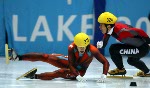 Mathieu Turcotte (319) is taken down by Jiajun Li from China during the Men's 1000 metre Semi Final in Salt Lake City, Utah Saturday Feb. 16, at the 2002 Olympic Winter Games. (CP Photo/COA/Andre Forget).