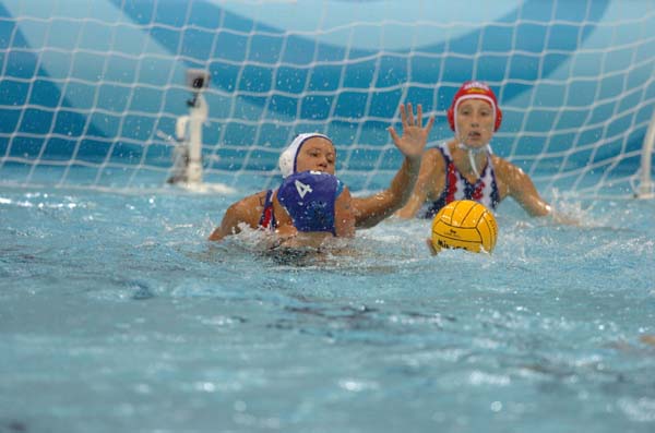 Canada's water polo player Sue Gardiner (#4) attempts a shot against the Russian defense player at the Olympic Games in Athens on August 16, 2004. (CP PHOTO 2004/Andre Forget/COC)