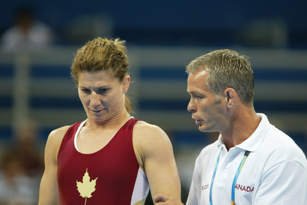 Canada's Tonya Verbeek of Beamsville, Ont., listens to her coach, Martin Calder.  Verbeek won the silver medal in the 55 kg category in women's wrestling finals at the Olympic Games in Athens Monday, August 23, 2004. (CP PHOTO)2004(COC-Mike Ridewood)