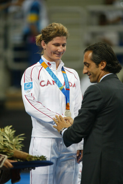 Canada's Tonya Verbeek of Beamsville, Ont., receives her silver medal won in the 55 kg category in women's wrestling at the Olympic Games in Athens, Monday, August 23, 2004.  (CP PHOTO)2004(COC-Mike Ridewood)