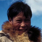 Colour photograph of an Inuit boy wearing a parka with a fur collar, Arviat (formerly Eskimo Point), Nunavut, 1936