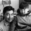 Photograph of Inuit man, Kananginaq, holding his son on his lap, unknown location, Nunavut, 1968