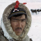 Colour photograph of an Inuit man wearing a hooded fur parka, Igloolik (Iglulik), Nunavut, May 1965